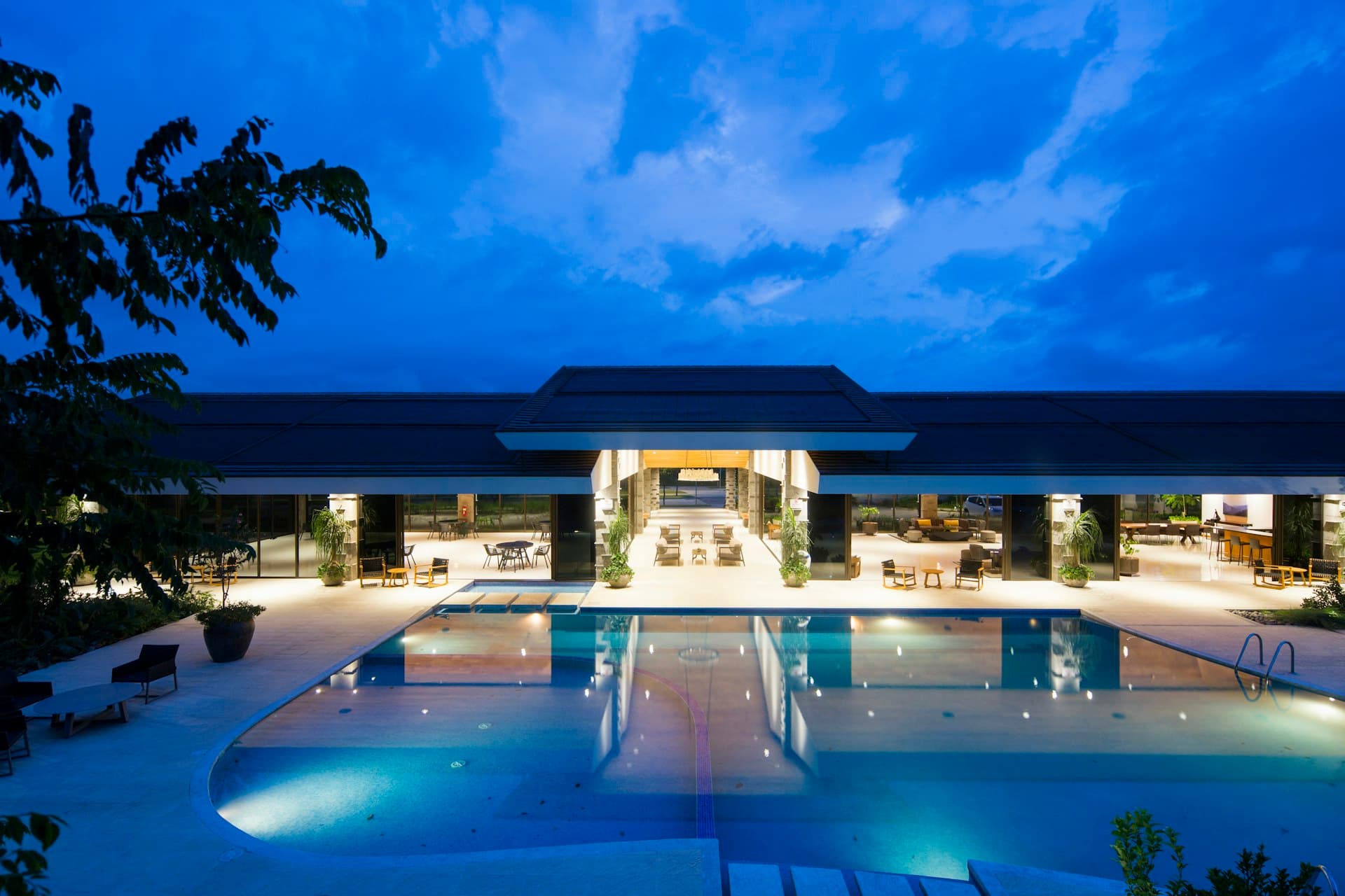 Luxury hotel facade reflected in water at dusk